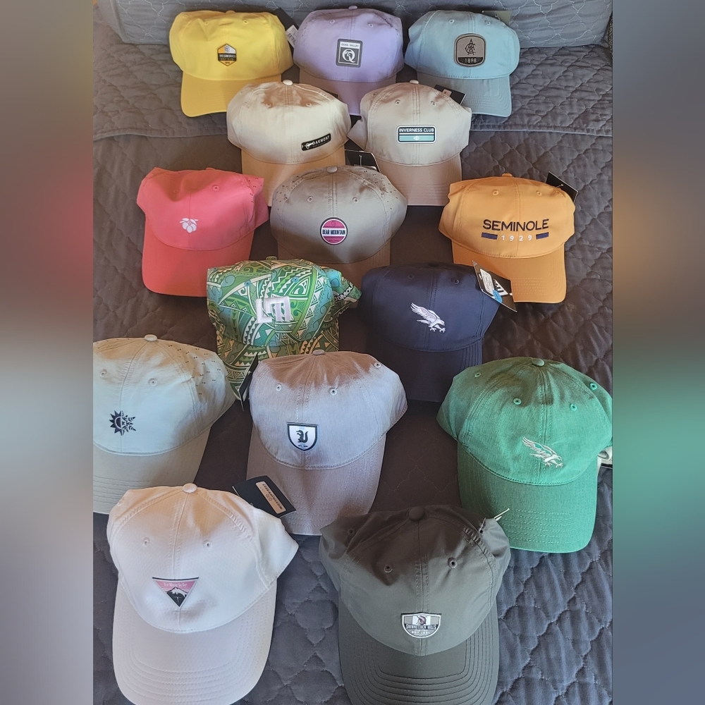 Assorted golf caps with various course logos